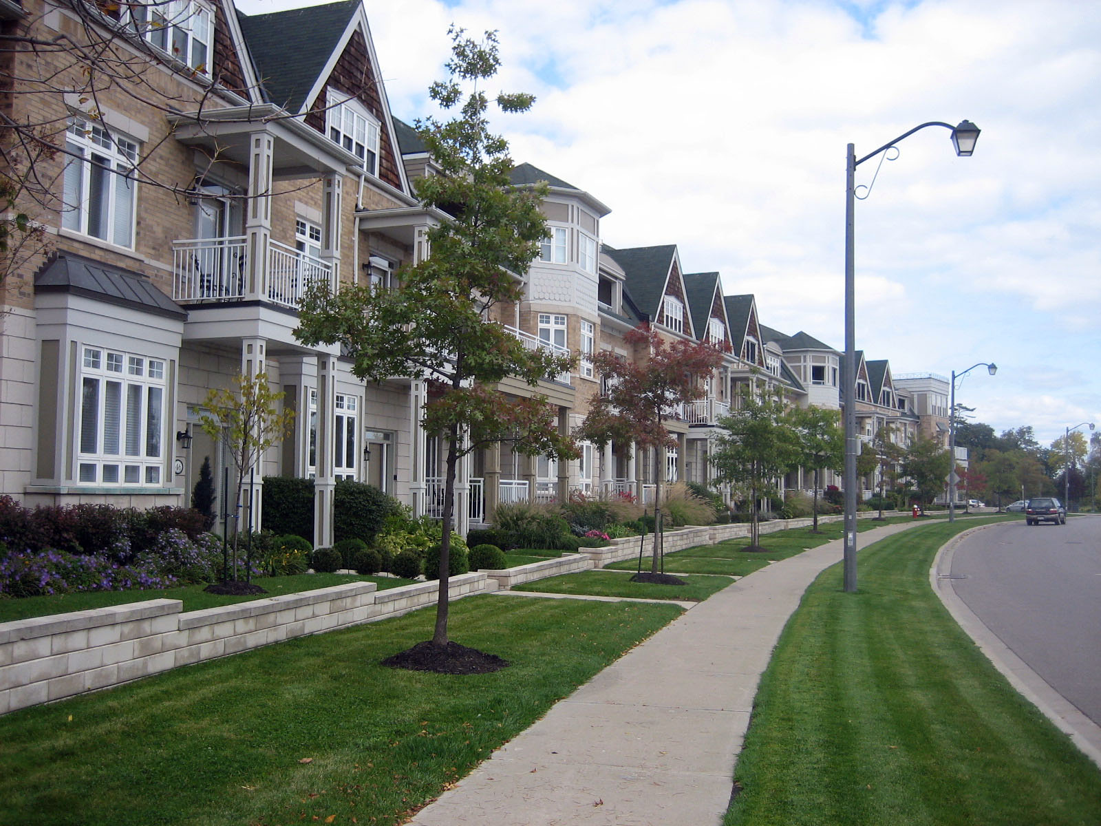 Row of modern townhouses facing a landscaped park path in Port Credit, Mississauga