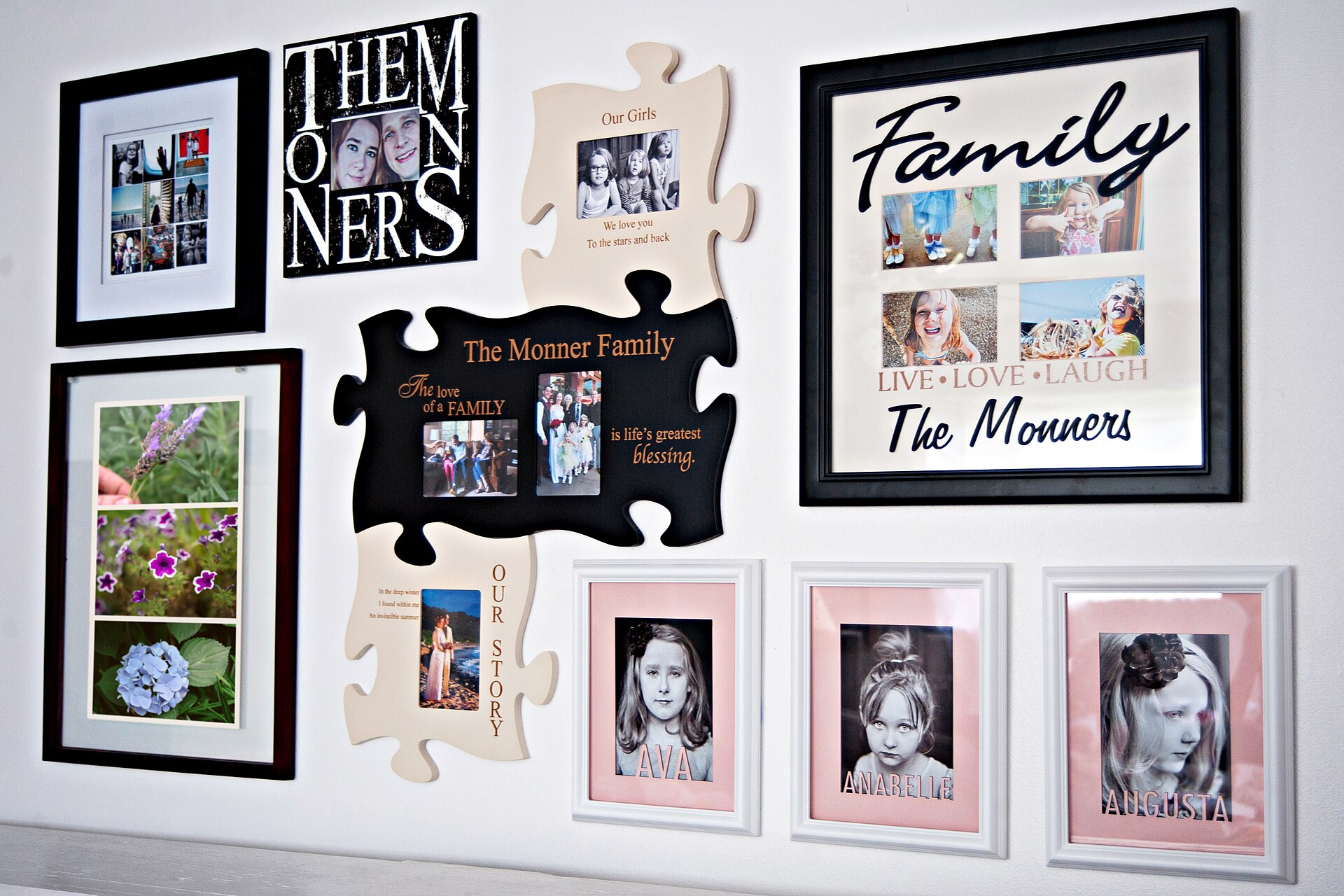White wall arranged with framed family photos, puzzle-piece frames and a large Family word-art frame